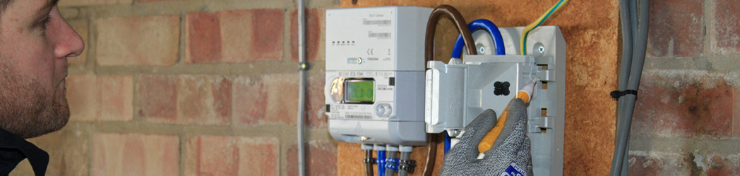 yu energy engineer installing a business smart meter