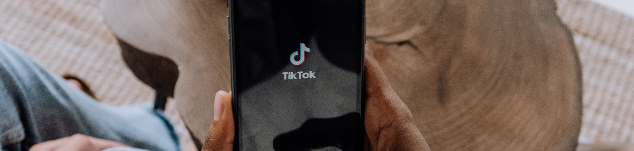 The tiktok logo in the centre of a mobile phone screen