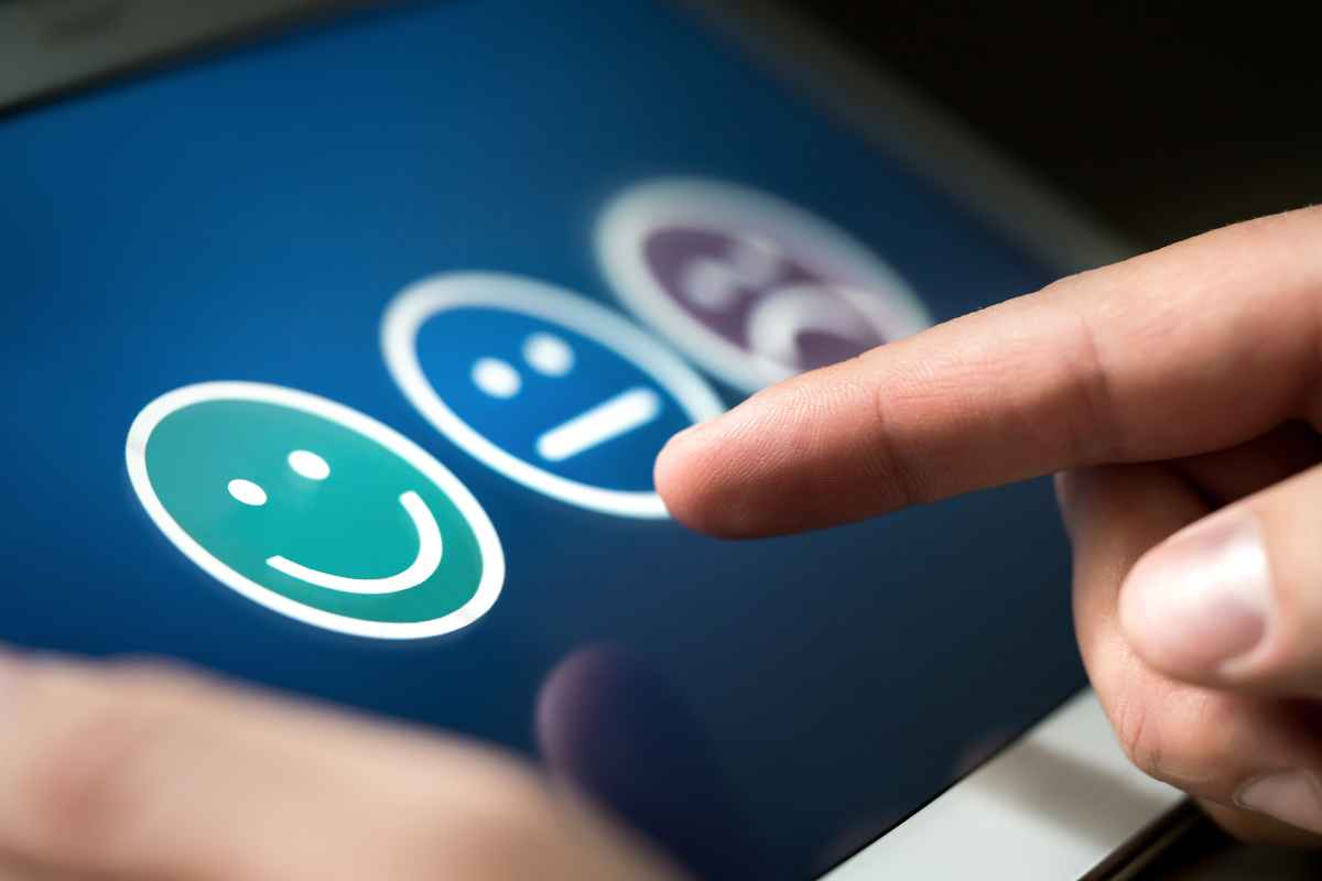 Why feedback is important for businesses planning the new year - three faces depicting happy neutral and sad on an ipad screen.